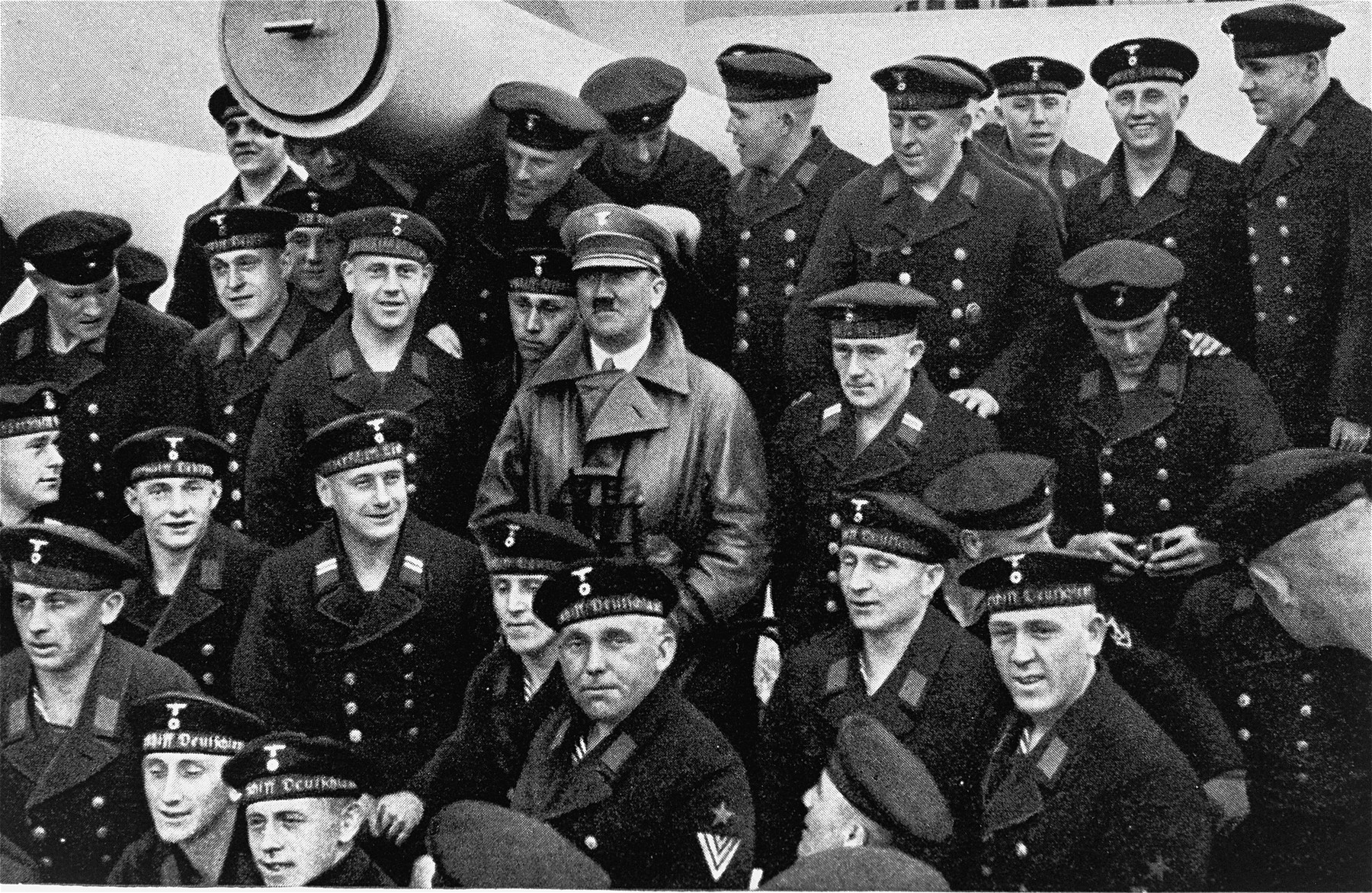 Adolf Hitler poses with a group of sailors aboard the Deutschland battleship
